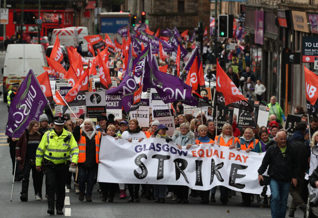 Strikers march to Glasgow Council's city chambers for a mass rally during a 48 hour strike by 8,000 GMB and Unison members over an equal pay claim. PRESS ASSOCIATION Photo. Picture date: Tuesday October 23, 2018. Thousands of female workers are proceeding with equal pay claims against the council following a Court of Session ruling last year. See PA story INDUSTRY Strike. Photo credit should read: Andrew Milligan/PA Wire