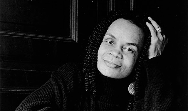 A medium shot black & white portrait of Sonia Sanchez, head leaning on hand