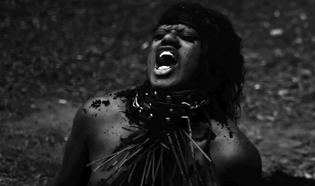 A B&W shot of M Lamar prostrate and seemingly screaming