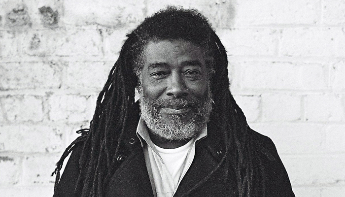 Portrait of Wadada Leo Smith in front of a white brick wall
