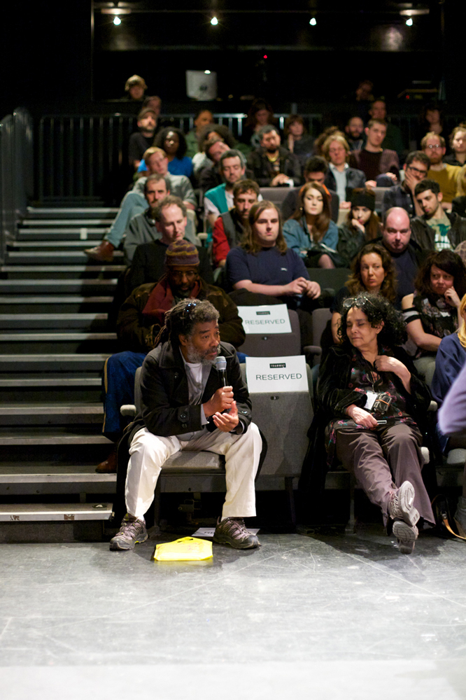Wadada Leo Smith leans forward and asks a question during the discussion