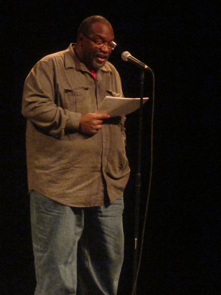 Fred Moten reads poetry at a microphone