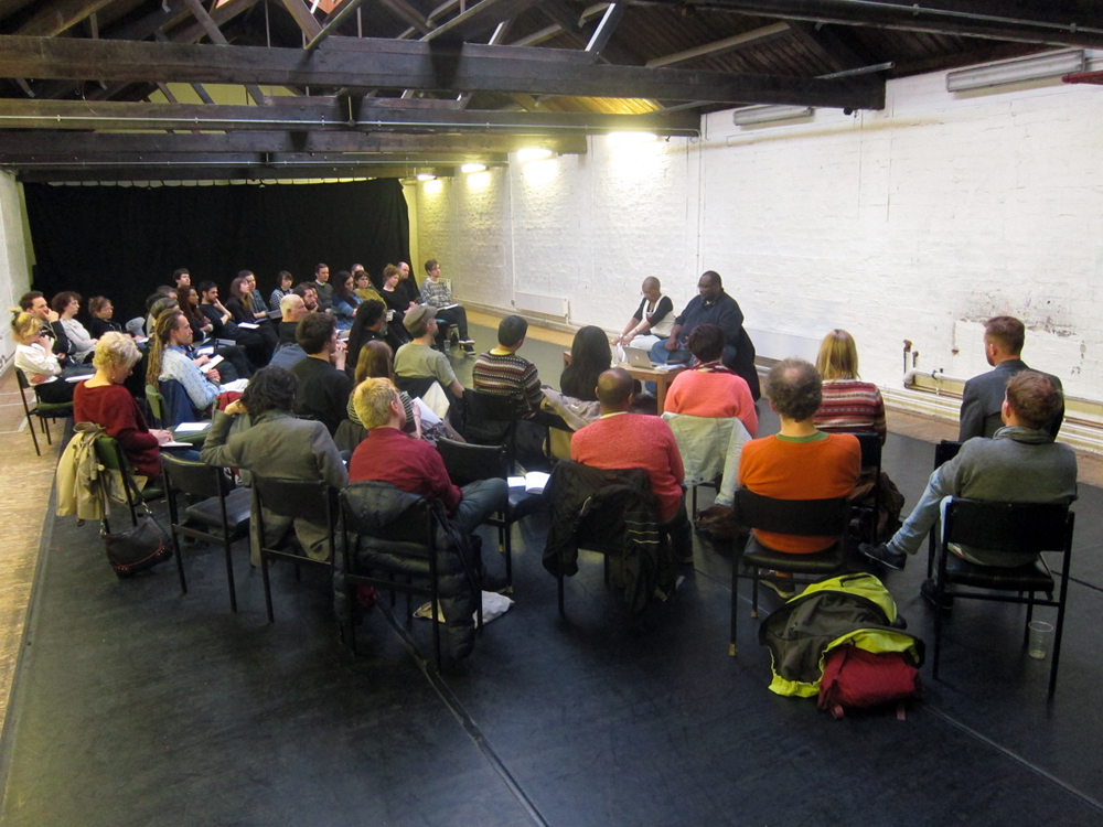 long shot of the audience gathered around to take part in the discussion