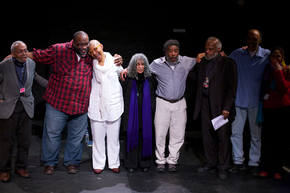 Some of the performers at Episode 4 give NourbeSe a hug after the performance