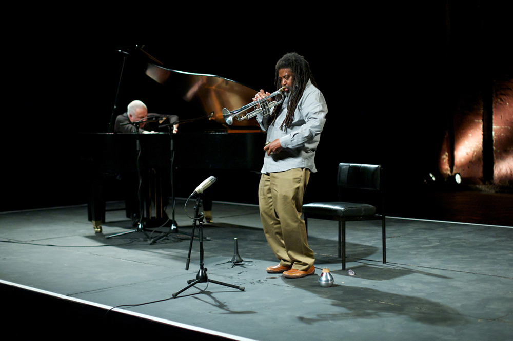 John Tilbury plays a piano whilst Wadada Leo Smith plays a trumpet