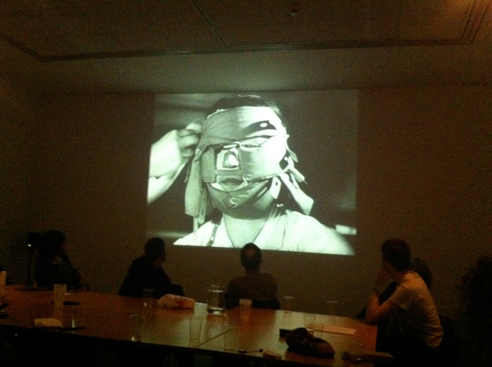 A shot of a screen showing a face swaddled in fabric