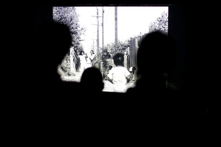 Silhouettes of audience heads as they watch Killer of Sheep on a screen