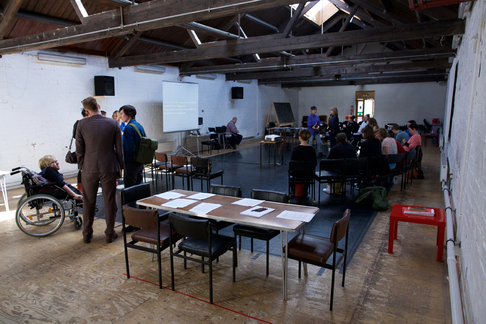 A long shot of a bright space with people milling around