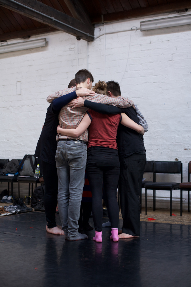 A group of participants gather in a group hug