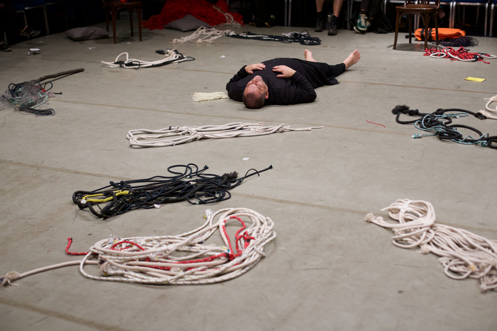 One member of Ueinzz lies on the floor with ropes all around