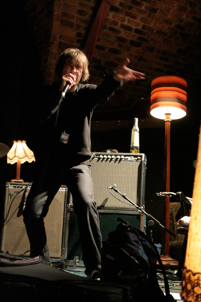 Richard Youngs stamps his foot and points as he sings energetically