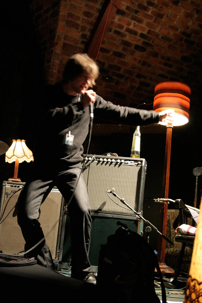 Richard Youngs stamps his foot and points as he sings energetically