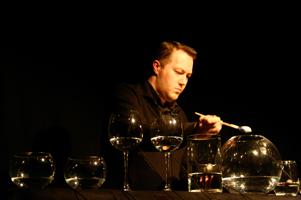 Lee Patterson adds a spoon of powder to a large glass of water