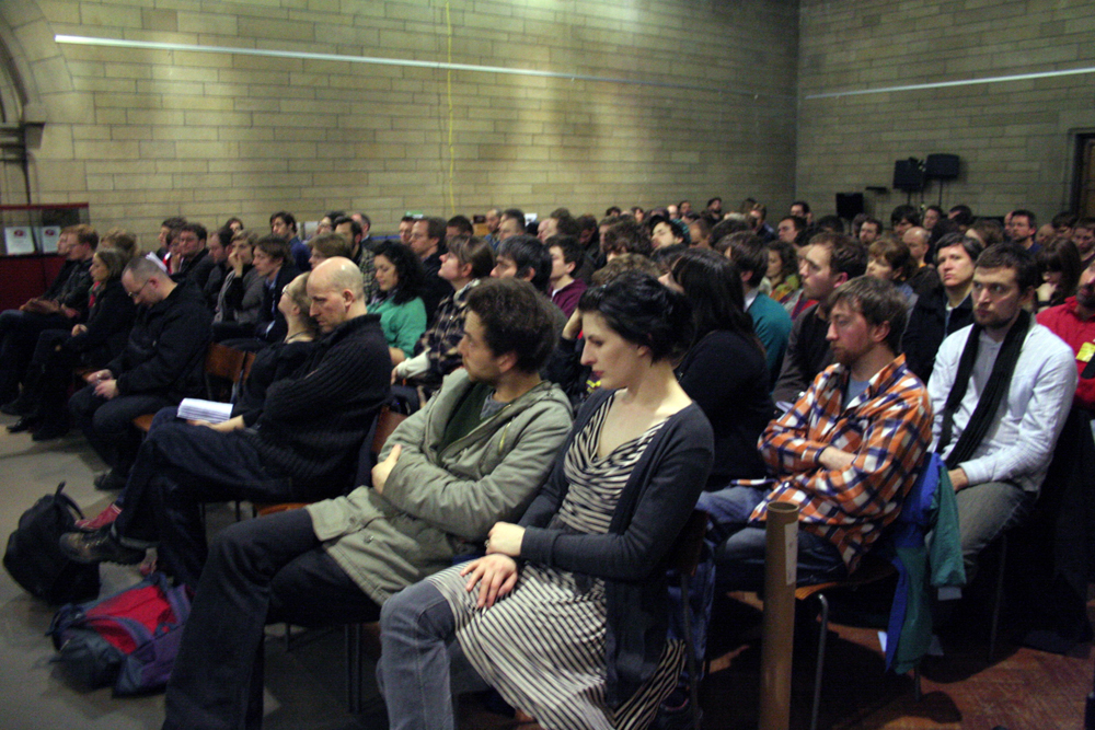 A large audience sits in a church space