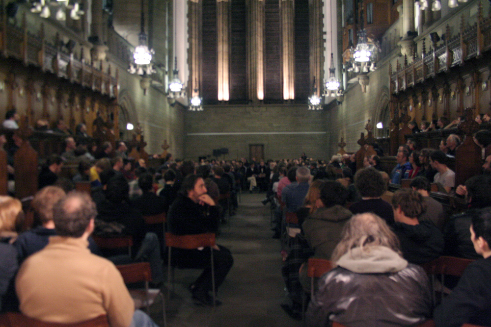 A large audience gathers in a church space