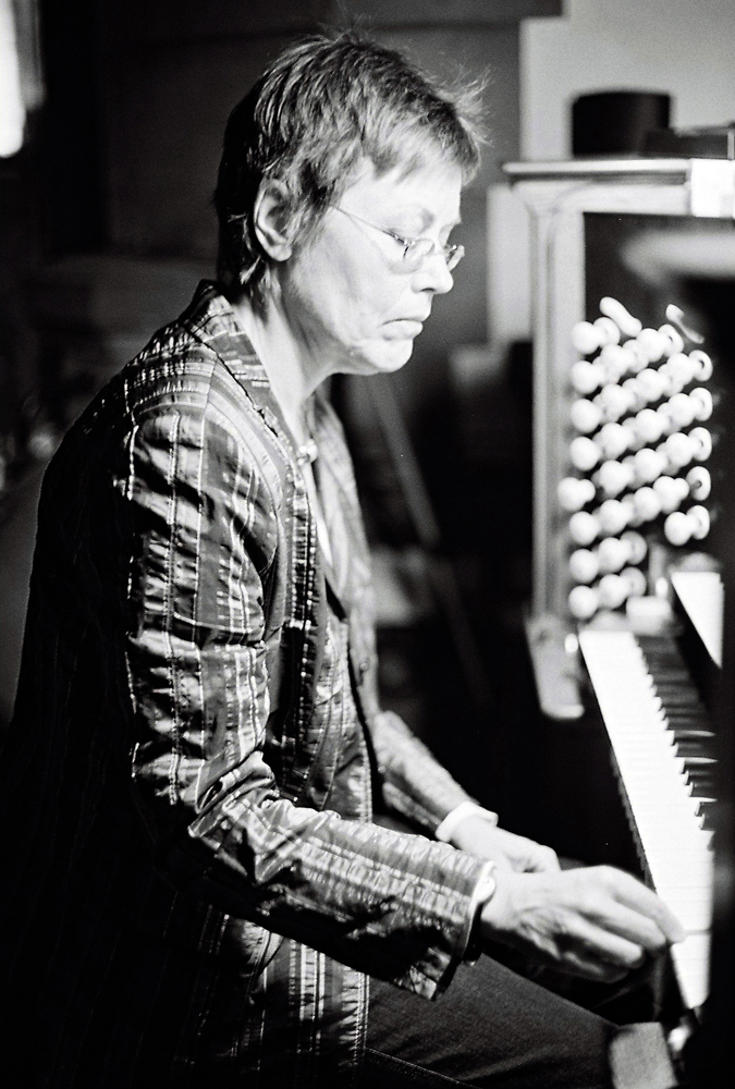 Eva Maria Houben looks down as she plays an organ