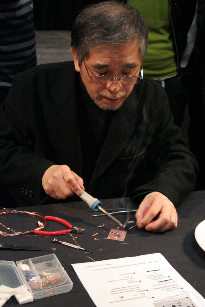 Tetsuo Kogawa uses a solder gun