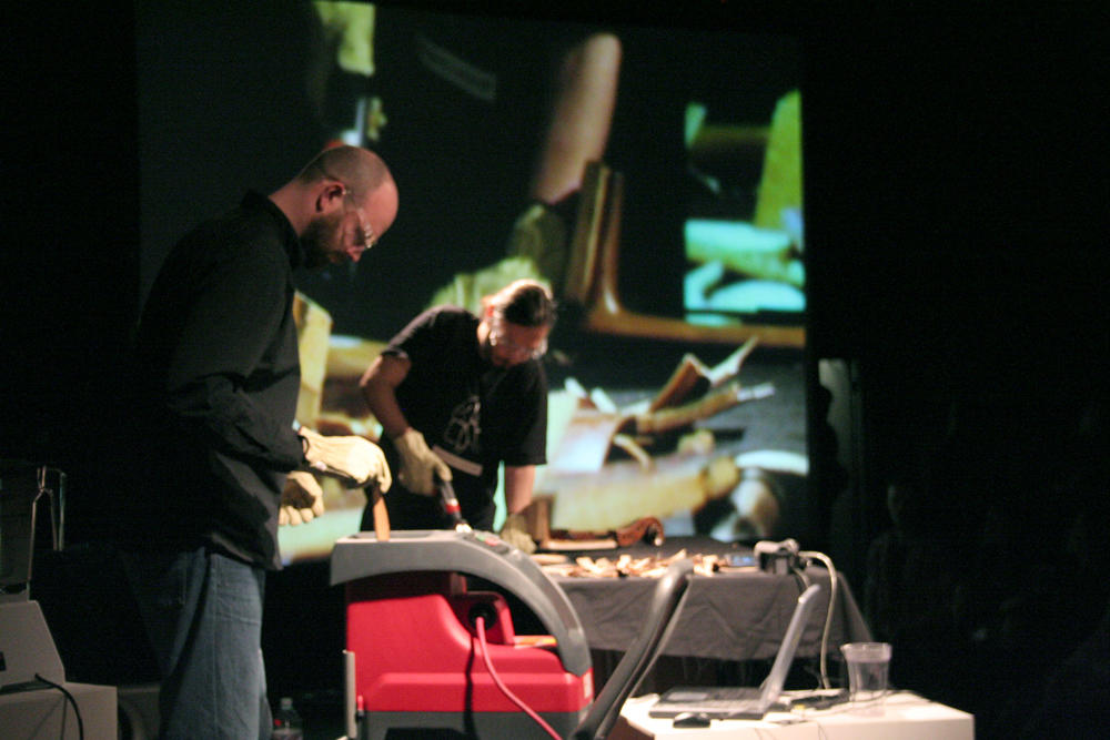 Nikos Veliotis and Rhodri Davies chip wood, cello and a projection in the back
