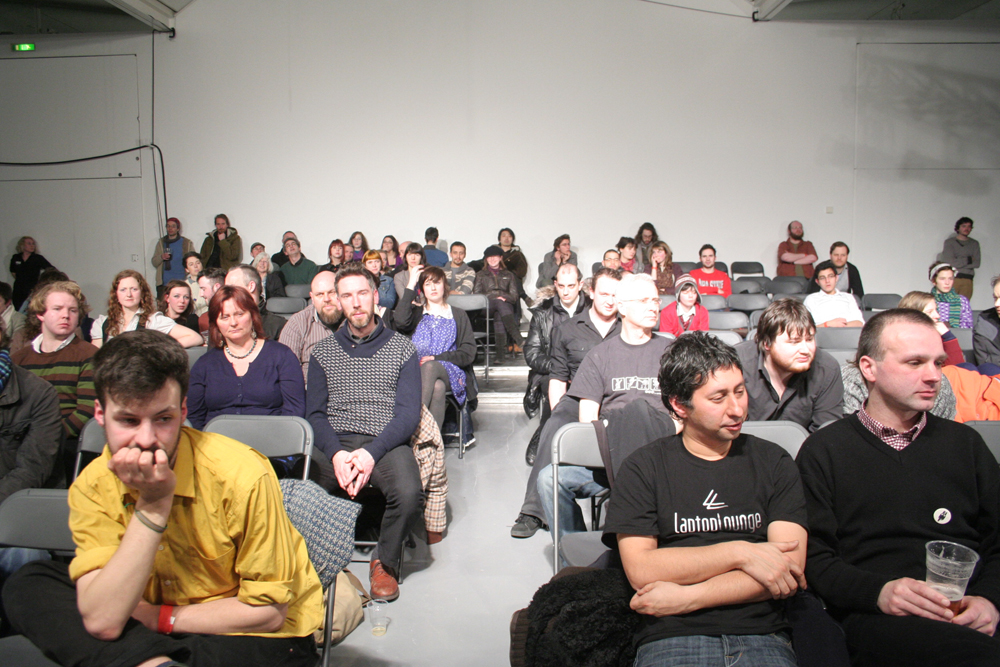 a front shot of a brightly lit audience
