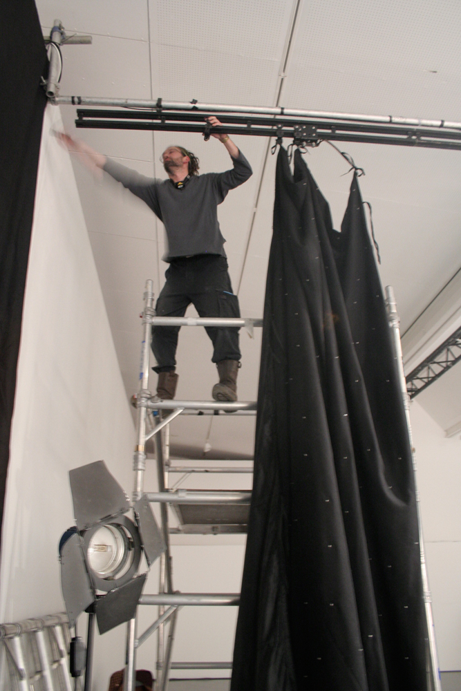 A crew member starts to dismantle the set