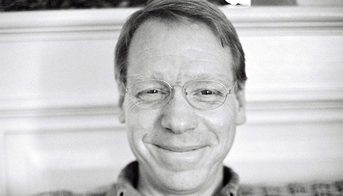 Michael Pisaro smiles into the camera against a light background