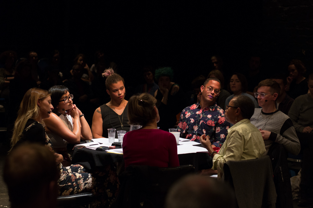 People sitting around a table listening and talking