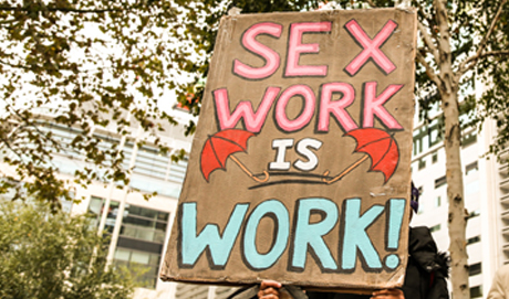 a banner with painted letters saying sex work is work