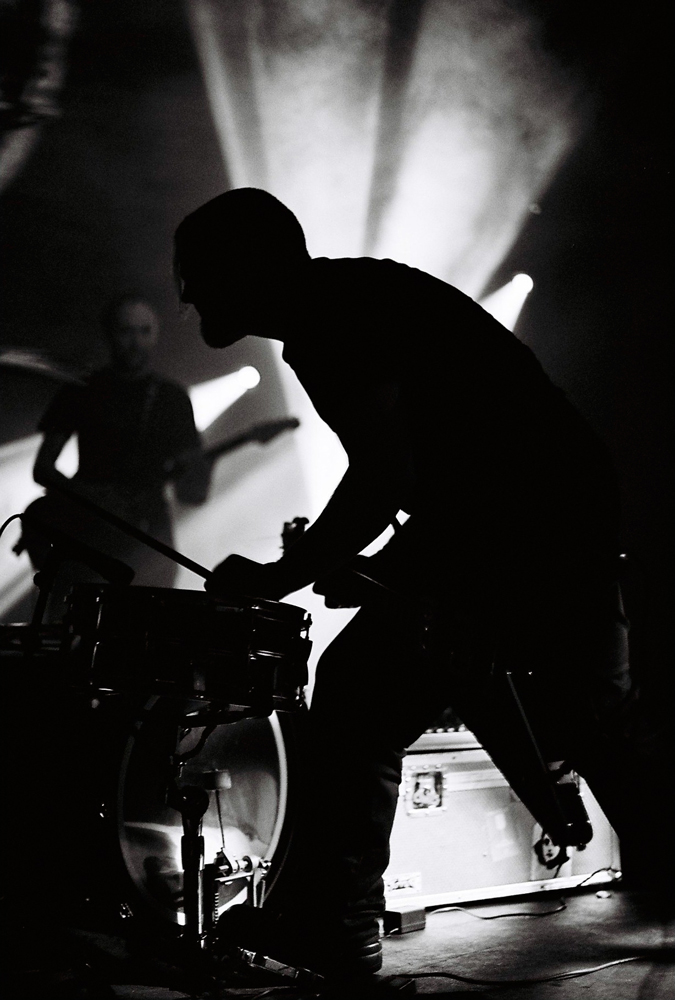 silhouettes of musicians bent in concentration
