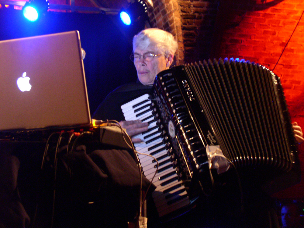 Pauline Oliveros playing an accordion 