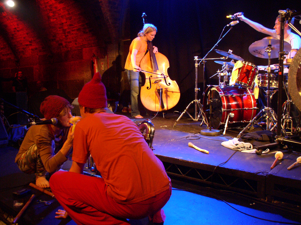 Rauhan Orkesteri performing on stage at INSTAL 05, bare feet, woolen hats