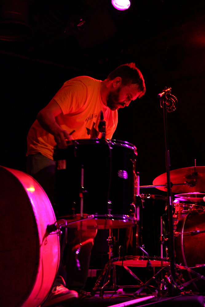 A drummer looks down onto some drums