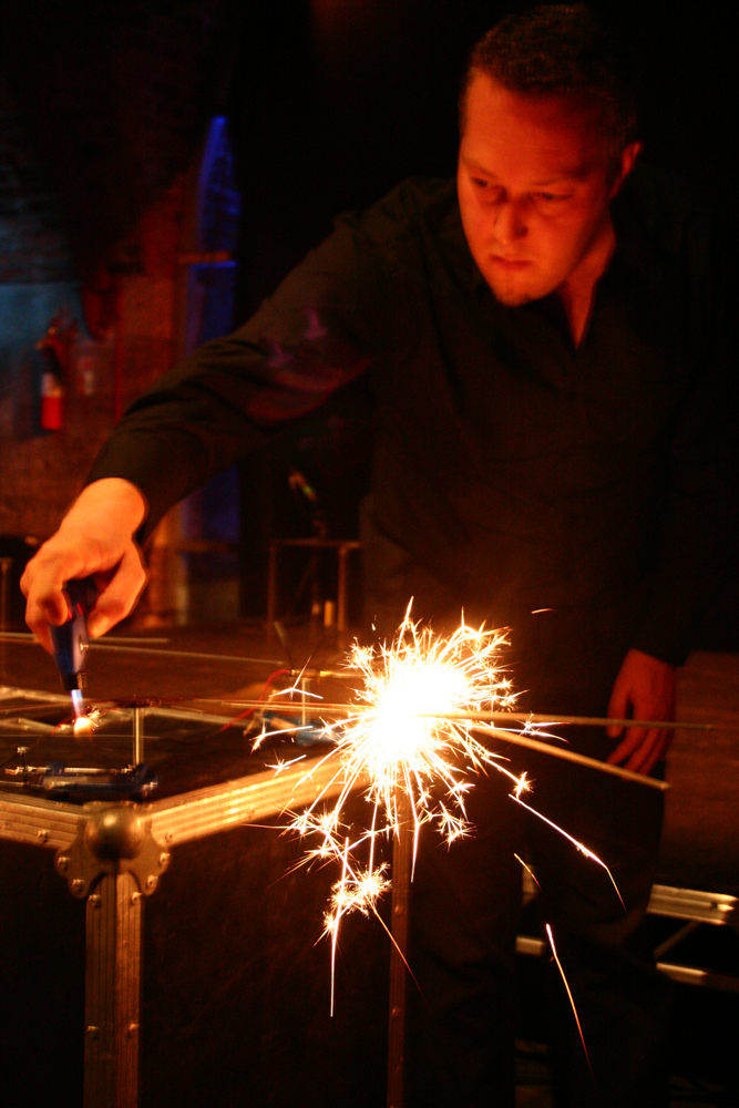 Sparklers mounted on stands with microphones being lit with a gas burner