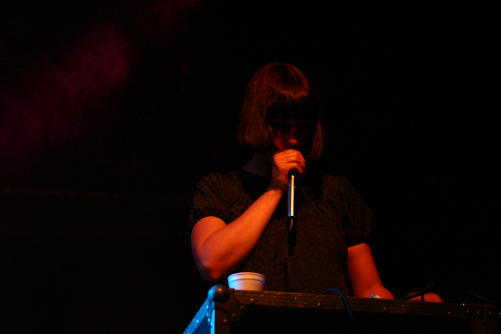 Karen Constance singing into a microphone