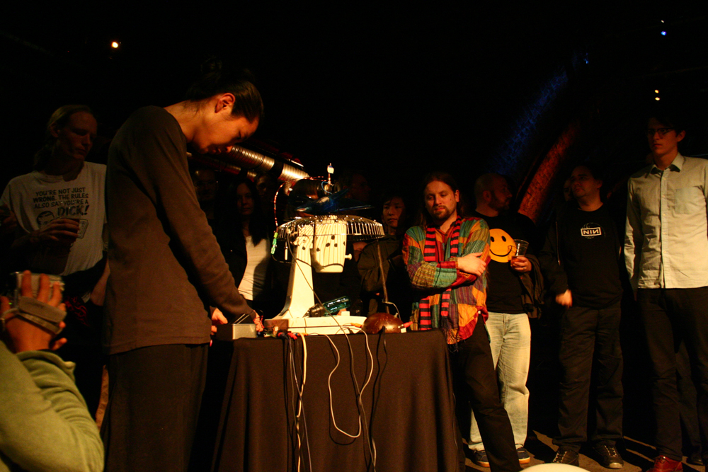 Tetsuya Umeda operating a machine next to an audience