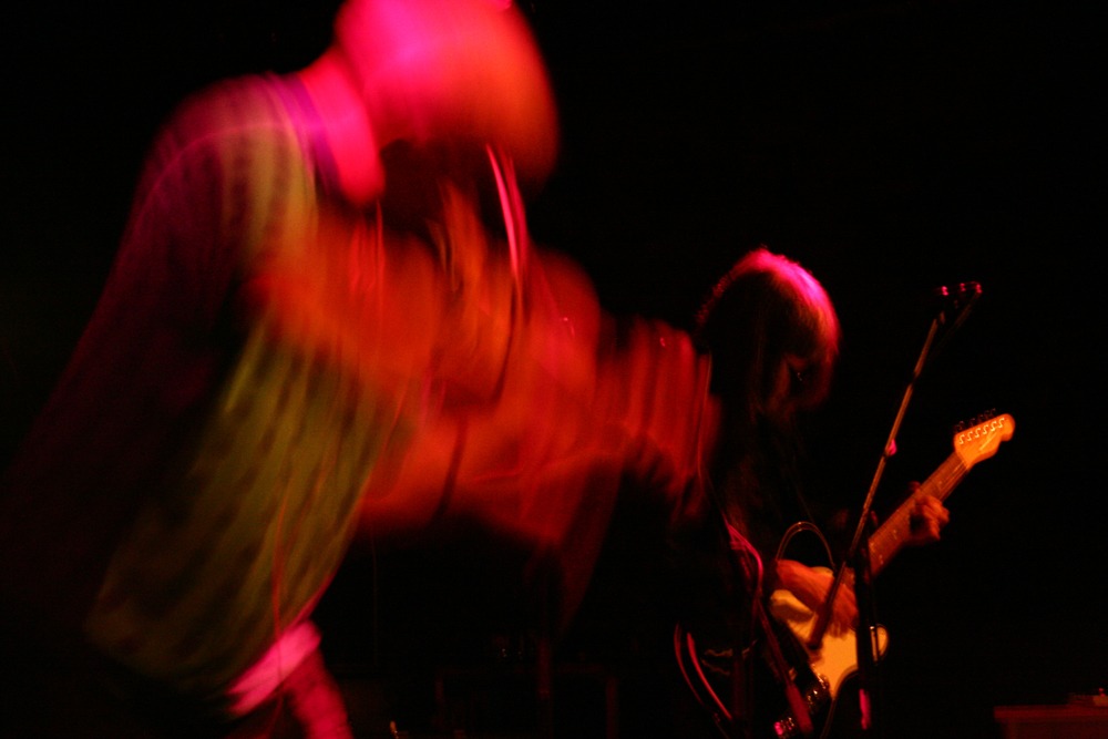 Tony blurred as he bows, Haino with guitar in background