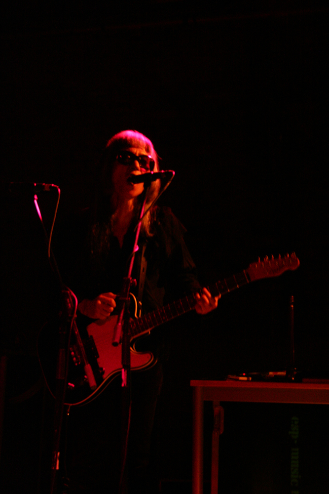 Keiji Haino playing a fender telecaster guitar and singing into a microphone
