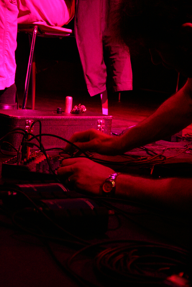 Close up of a man's hands adjusting a mixer, he is wearing a watch