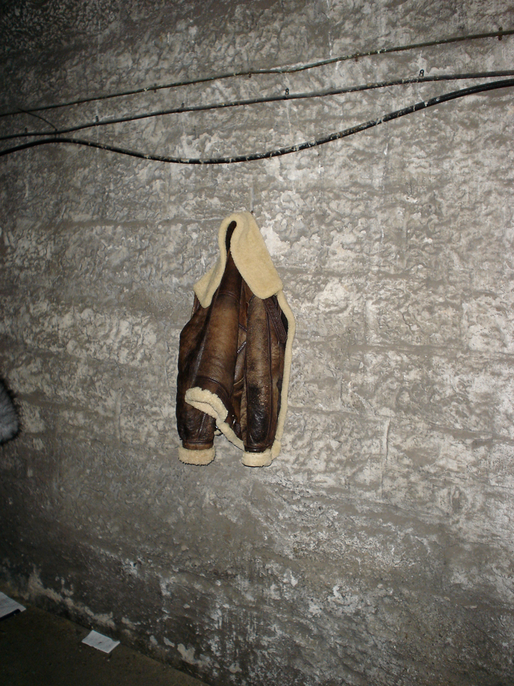 A jacket leather hanging on a wall inside Glasgow University bell tower