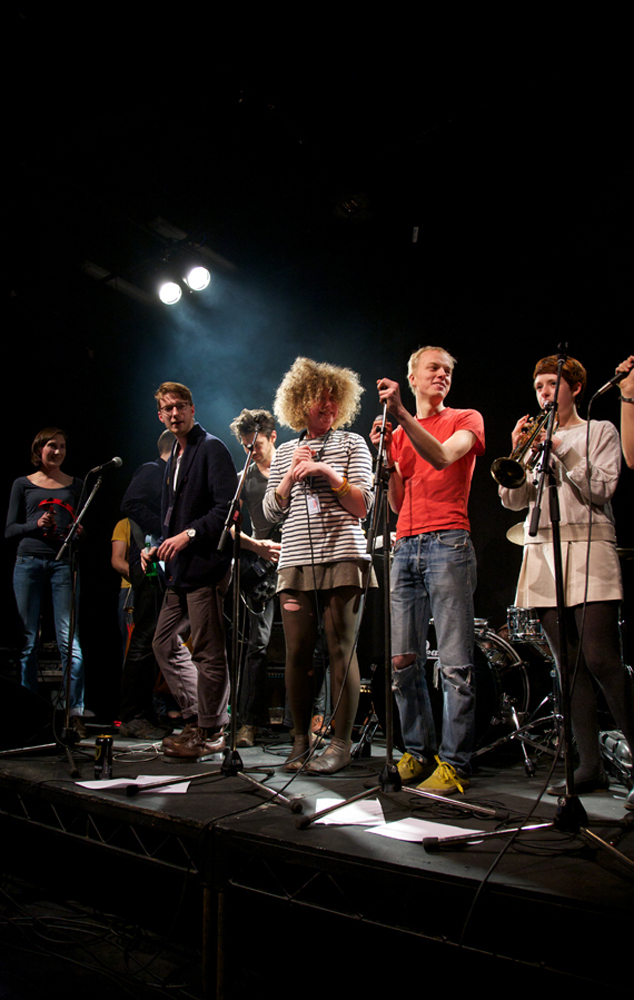 A large covers band comprising young people on stage 
