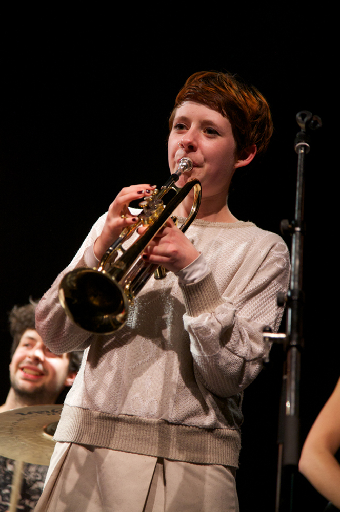 A trumpet player performs on stage 