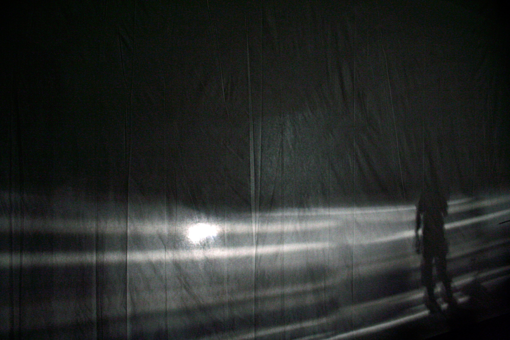 Grey bands of light against a sheet of fabric