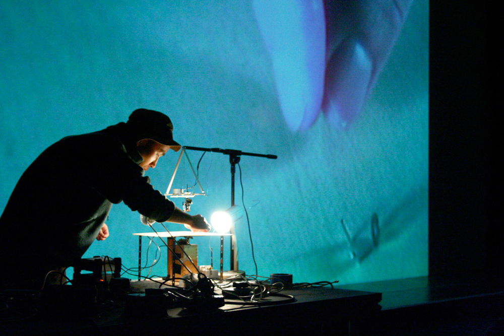 Kanta Horio operating an electro-magnet in front of a projection