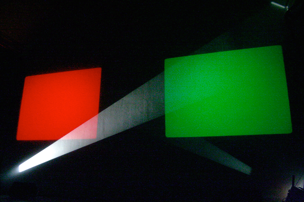 A rectangle of red light, one of green light and a beam of white light