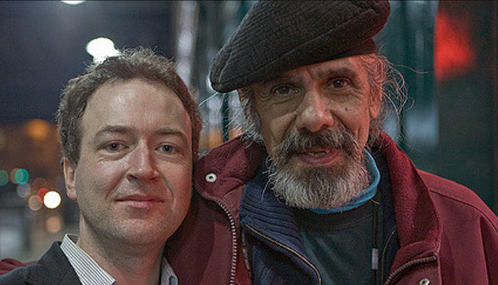 David Keenan and Alan Silva who wears a black beret and red jacket smile