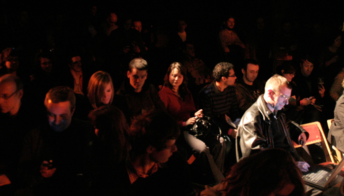 Achim Wollschied sits amongst the audience with a laptop