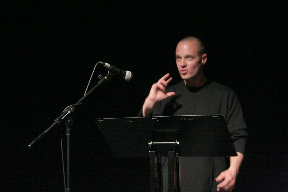 Craig Dworkin standing by a microphone