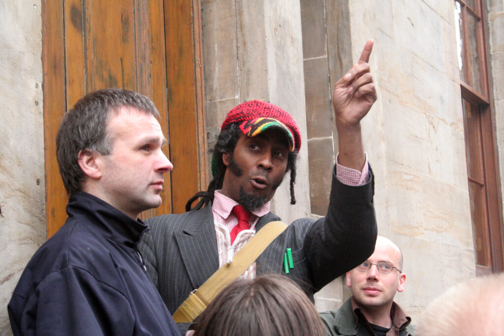 Some people standing near a wall