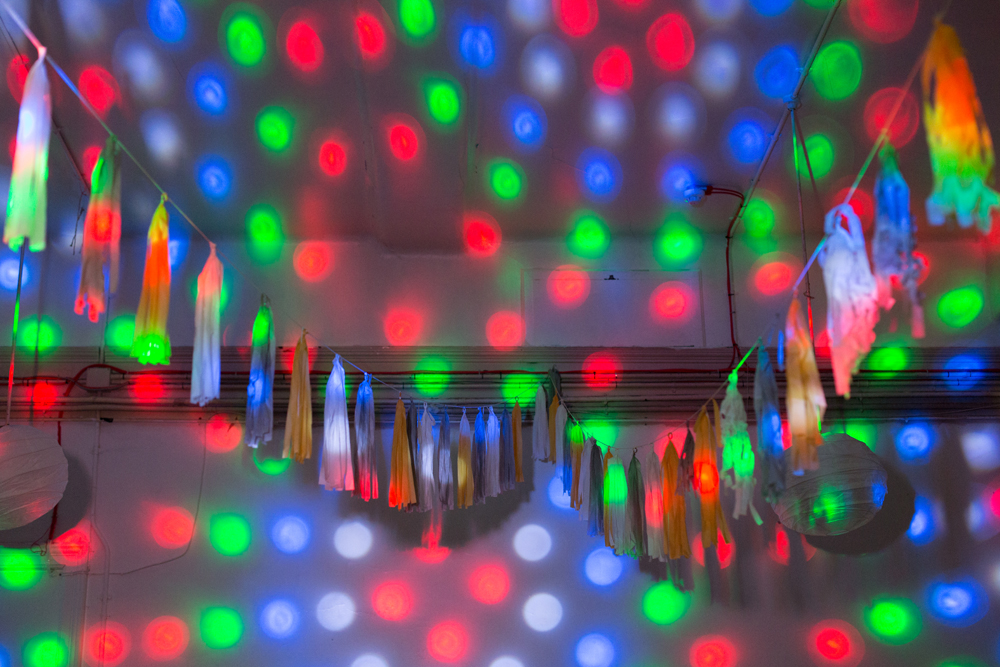 Disco lights on festoons on a wall
