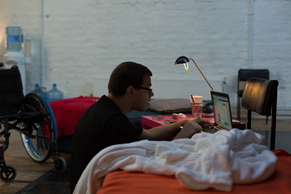 Robert Softley Gale working at a computer next to a bath robe