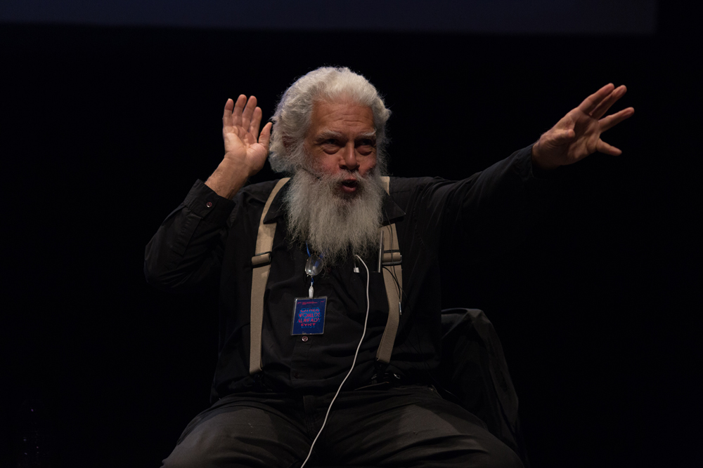 Samuel Delany gesturing with his hands during a talk at EPISODE 9